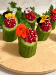 Cucumber appetizers stuffed with beet hummus
